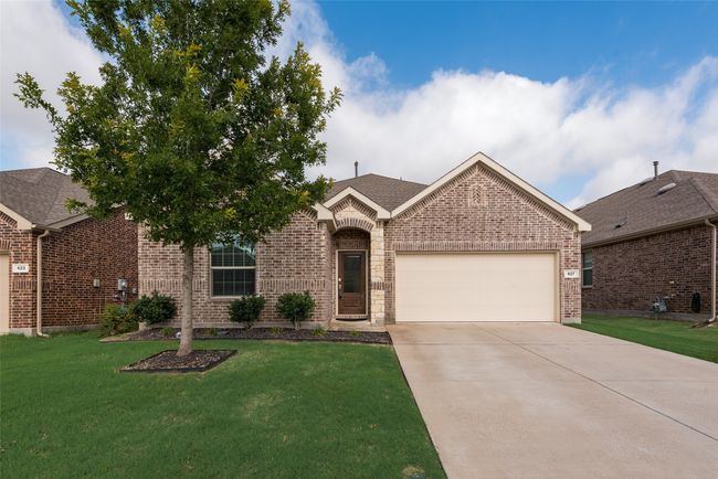 View of front of property featuring brick siding, an attached garage, concrete driveway, and a front yard | Image 25