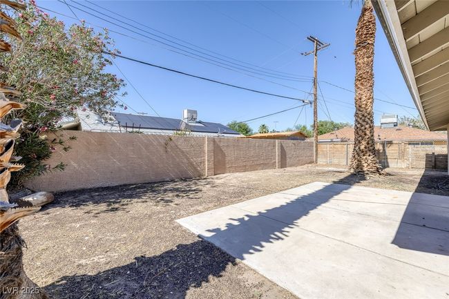 Fenced backyard with a patio | Image 29