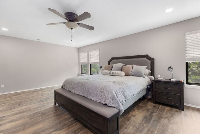 Bedroom with dark wood-style floors, recessed lighting, a ceiling fan, and baseboards | Image 23