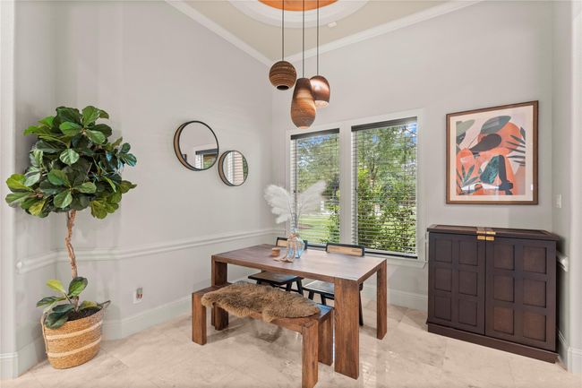 The charming dining room presents an inviting atmosphere with refined details, creating an ideal space for intimate dinners and memorable entertaining. | Image 20