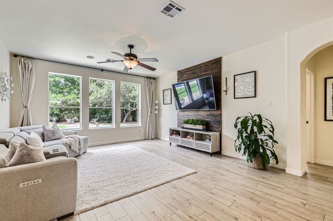 Bright and airy living room with large windows to the outdoors | Image 7