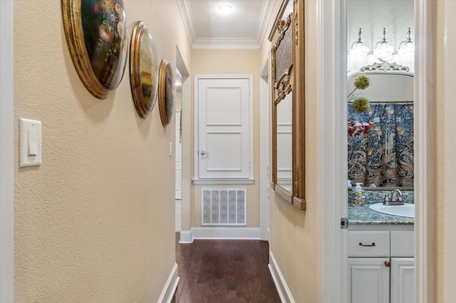 Hallway with a sink, ornamental molding, dark wood-style flooring, baseboards, and a textured wall | Image 19
