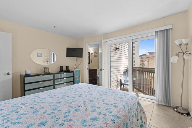 Tiled bedroom featuring access to outside and ensuite bathroom | Image 27