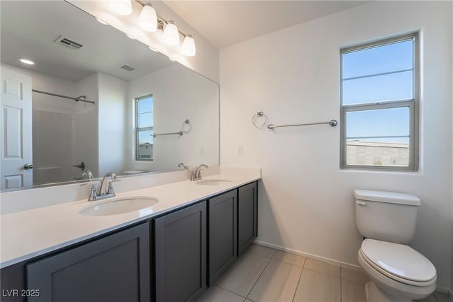 Upstairs Bathroom featuring double vanity, tile patterned flooring, and shower combination | Image 36