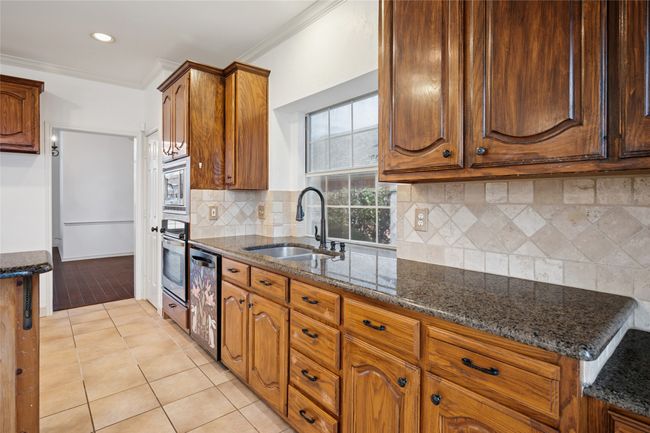 Granite countertop prep area. Sink, dishwasher and built in stainless steel convection oven and microwave | Image 17