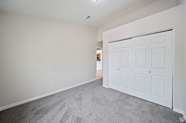 Unfurnished bedroom with carpet floors and a closet | Image 15
