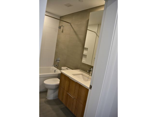 Bathroom with shower / bathtub combination, visible vents, toilet, and vanity | Image 13