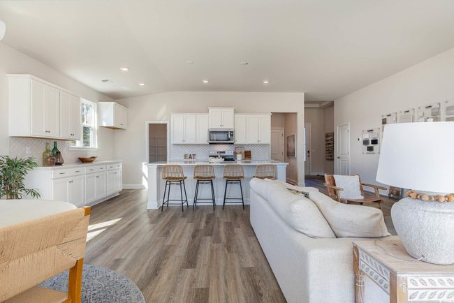 Living area featuring light wood-style flooring, recessed lighting, vaulted ceiling, and baseboards | Image 14