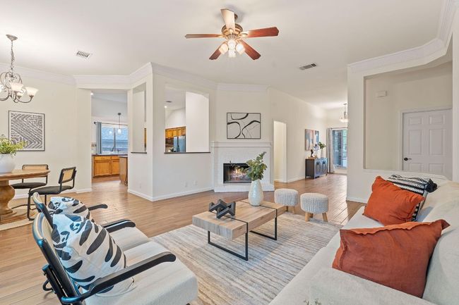 The inviting interior boasts soaring ceilings, crown molding, recessed lighting, and durable wood-look tile flooring throughout. | Image 11