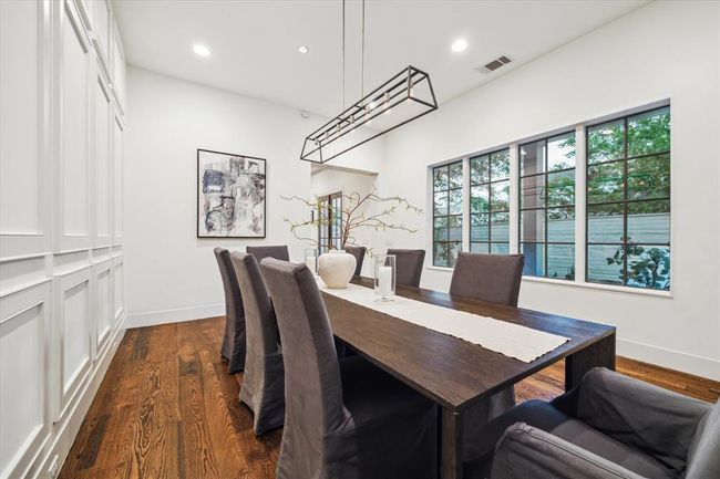 FORMAL DINING. Note the designer light fixtures throughout the entire home. Enjoy Sonos Surround Sound in the dining, kitchen and pool area. | Image 6