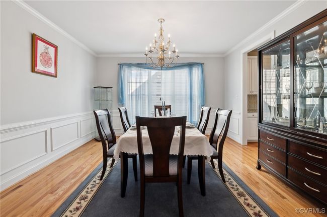 Fresh, neutral paint in the formal dining room which contrasts nicely with the crown, picture, and chair rail molding. | Image 28