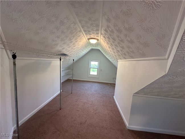 Bonus room with lofted ceiling, a textured ceiling, carpet flooring, and baseboards | Image 29