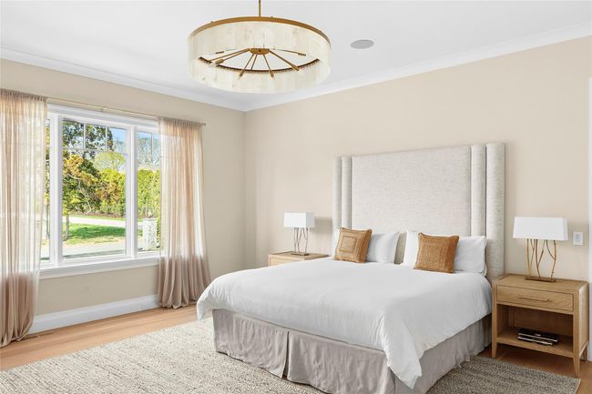 Bedroom featuring wood floors and en-suite | Image 14