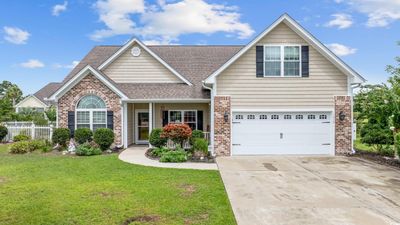 View of front of property with a garage and a front lawn | Image 1