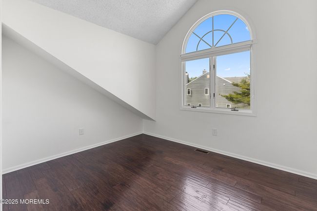 Versatile 2nd bedroom with impressive arched transom window. | Image 17