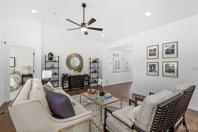 Living room with a ceiling fan, high vaulted ceiling, wood finished floors, baseboards, and recessed lighting | Image 23