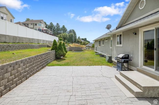 View of patio featuring area for grilling | Image 41
