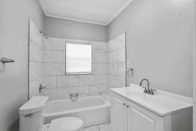 Bathroom featuring vanity, shower combination, and marble finish flooring | Image 15