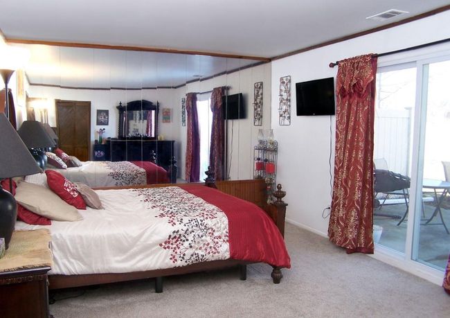 Bedroom featuring multiple windows, carpet floors, crown molding, and baseboards | Image 10