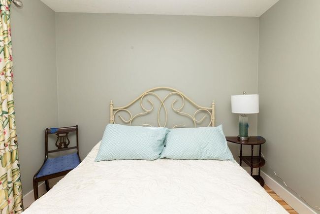 Bedroom with baseboards and wood finished floors | Image 15