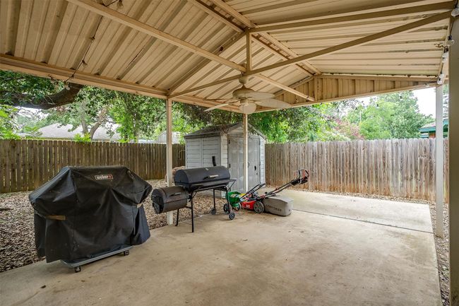 Fenced backyard featuring a grill, a patio, and a shed | Image 33