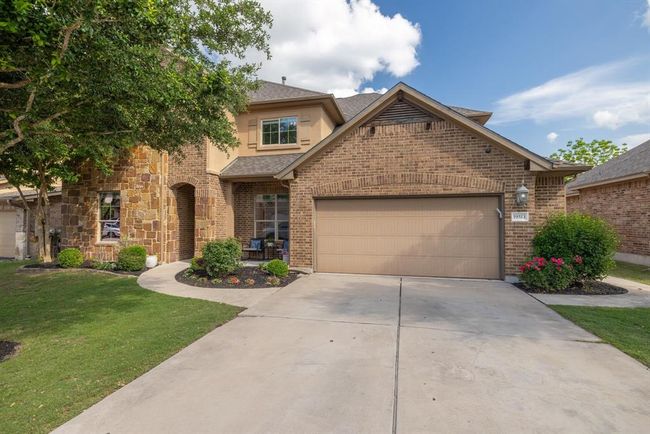 View of front of home with a front yard, a garage, concrete driveway, brick siding, and a shingled roof | Image 11