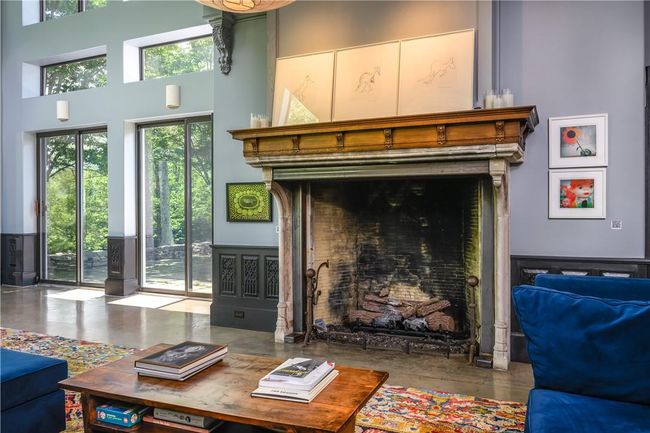 Living room featuring a high ceiling and concrete floors | Image 10