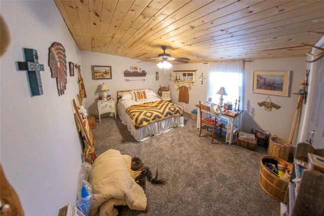 Carpeted bedroom featuring vaulted ceiling, ceiling fan, and wooden ceiling | Image 18