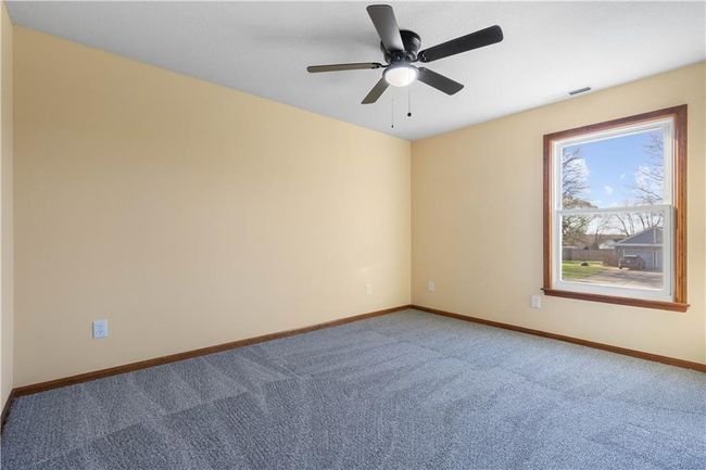 Carpeted spare room featuring visible vents, baseboards, and a ceiling fan | Image 31