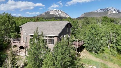 View of front of property featuring a wooden deck | Image 1