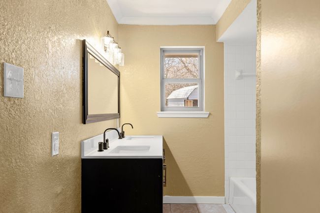 Full bath featuring a textured wall, ornamental molding, tile patterned flooring, and vanity | Image 17