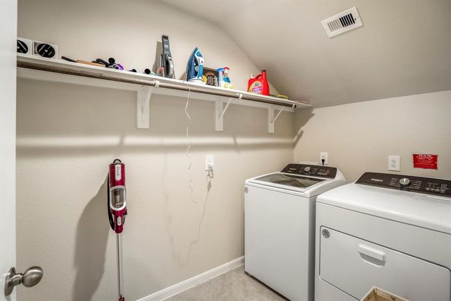 The laundry room is spacious enough to store your vacuum cleaner as well as offering hanging space for those items just out of the washer. | Image 7