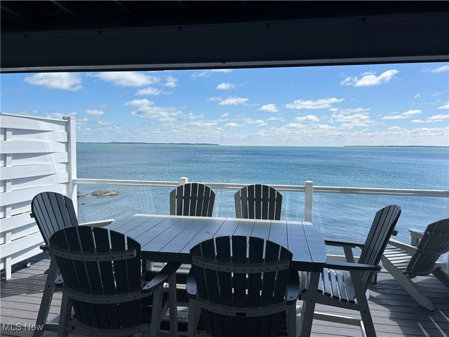 Deck featuring outdoor dining space and a water view | Image 10