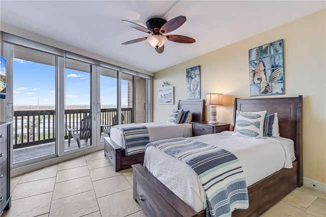Twin bed guest room with pool and bay views. | Image 21