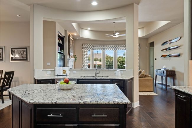 Kitchen Features Granite Countertops, Gas Cooking and Center Island | Image 12