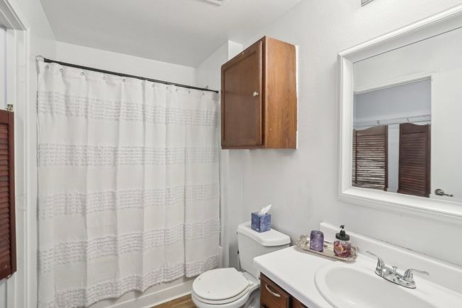 Full bathroom featuring vanity, shower / bath combo, and toilet | Image 11