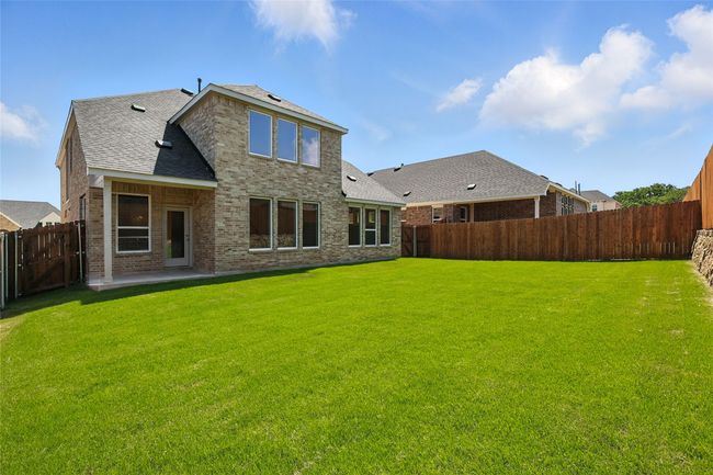 Back of house with a fenced backyard, a shingled roof, brick siding, and a patio area | Image 32