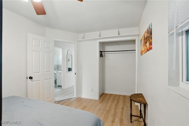 Bedroom featuring light wood-style flooring, a closet, and ceiling fan | Image 27