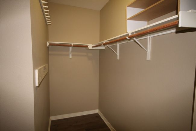 Walk in closet with wood finished floors | Image 15