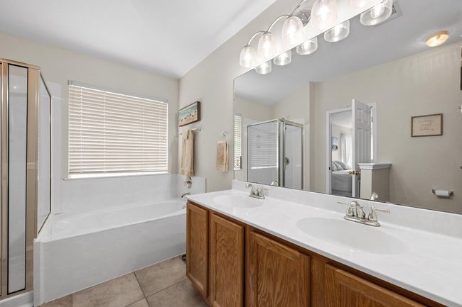 Primary bathroom dual sinks & walk-in closet | Image 21