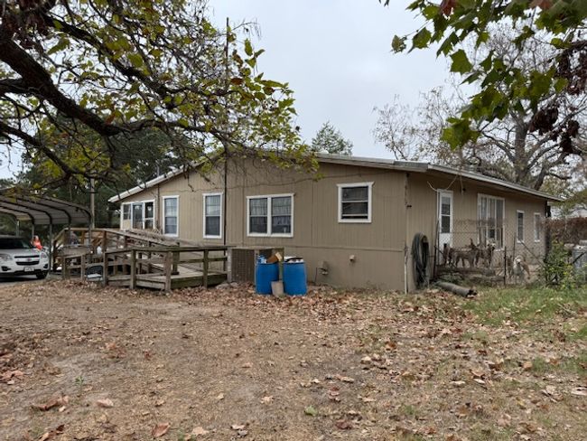 Rear view of property with a carport and ramp access | Image 9