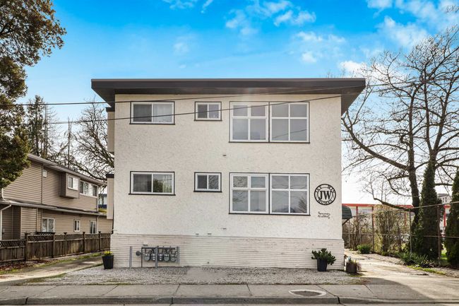 Rear view of house with stucco siding and fence | Image 26