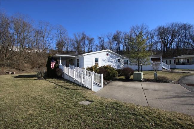 Off Street Parking for 2 Vehicles on Concrete Pad & Ramp to Covered Porch & Entrance | Image 8