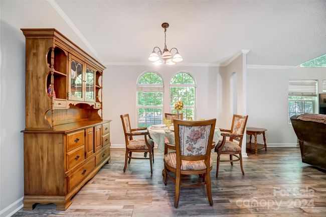 The inviting dining area welcomes you and your guests from the main living space and the kitchen. | Image 11