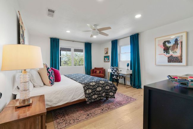 Bedroom featuring a ceiling fan, light wood flooring, and recessed lighting | Image 21