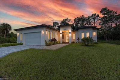 Contemporary house featuring a garage and a lawn | Image 3