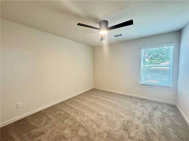 The secondary bedroom is a cozy and comfortable space, with ample room for a bed and additional furniture | Image 17