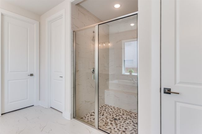 Bathroom with a marble finish shower, marble look tile flooring, and recessed lighting | Image 23