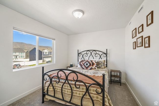 Carpeted bedroom featuring baseboards and a textured ceiling | Image 27