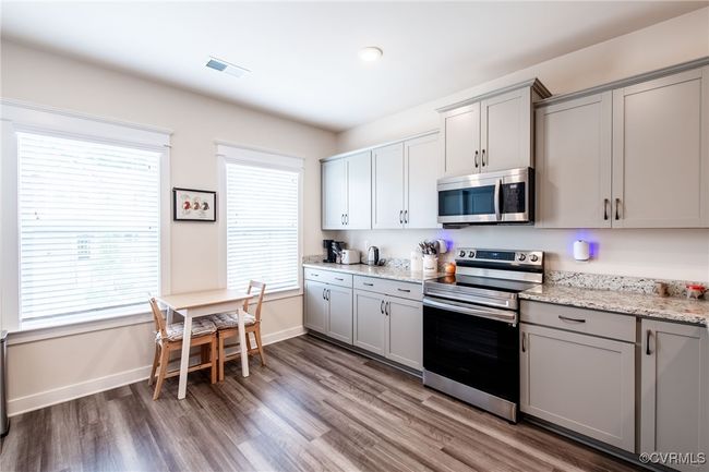 Kitchen featuring stainless steel appliances, gray cabinetry, and wood finished floors | Image 7
